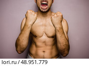 Athletic young man with his fists raised. Стоковое фото, агентство Ingram Publishing / Фотобанк Лори