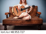 Young woman is playing guitar. Стоковое фото, агентство Ingram Publishing / Фотобанк Лори