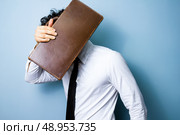 Businessman hiding behind his briefcase. Стоковое фото, агентство Ingram Publishing / Фотобанк Лори