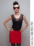 Young fashionable woman in round sunglasses posing in guipure dress. Red lips. Updo, twisted high bun. top knot. Стоковое фото, агентство Ingram Publishing / Фотобанк Лори