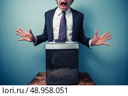 Businessman has got his tie stuck in a paper shredder. Стоковое фото, агентство Ingram Publishing / Фотобанк Лори