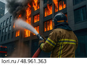 Пожарный в полной экипировке тушит огонь в многоэтажном здании. Он стоит спиной к камере, направляя мощную струю воды из тяжёлого пожарного шланга прямо в окна, из которых вырывается пламя. По фасаду поднимается густой чёрный дым. Чётко видны элементы формы: защитный шлем, куртка с отражающими полосами, перчатки. На заднем плане — современное здание и пожарная машина. Сцена подчёркивает опасность, решительность и значимость профессии пожарного, отражая реальную работу в условиях чрезвычайной ситуации. Стоковое AI-изображение, AI-художник Sergey Starostin / Фотобанк Лори
