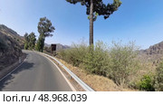 GRAN CANARIA, SPAIN - AUGUST 02, 2024: View from moving vehicle on GC-15 turning onto GC-150 road toward Galdar. Mountainous landscape in central Gran Canaria. Редакционное видео, видеограф Sergey Kohl / Фотобанк Лори