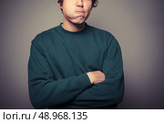 A young man is gesturing and pulling silly faces. Стоковое фото, агентство Ingram Publishing / Фотобанк Лори
