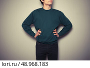 A young man is standing in a powerful pose. Стоковое фото, агентство Ingram Publishing / Фотобанк Лори