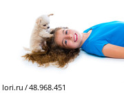 relaxed kid girl and puppy chihuahua dog playing hair lying on white background. Стоковое фото, агентство Ingram Publishing / Фотобанк Лори