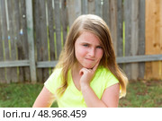 kid girl with disappoint expression finger thinking expression outdoor. Стоковое фото, агентство Ingram Publishing / Фотобанк Лори