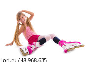 blond pigtails roller skate girl sitting happy on white background. Стоковое фото, агентство Ingram Publishing / Фотобанк Лори