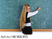 Clever nerd pupil blond girl writing in green board student schoolgirl. Стоковое фото, агентство Ingram Publishing / Фотобанк Лори