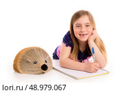 Blond kid girl student with hedgehog book on white background. Стоковое фото, агентство Ingram Publishing / Фотобанк Лори