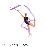 Kid girl ribbon rhythmic gymnastics exercise on white background. Стоковое фото, агентство Ingram Publishing / Фотобанк Лори