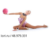 Kid girl ball rhythmic gymnastics exercise on white background. Стоковое фото, агентство Ingram Publishing / Фотобанк Лори
