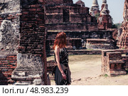 A young woman is exploring the ancient ruins of a buddhist temple city. Стоковое фото, агентство Ingram Publishing / Фотобанк Лори