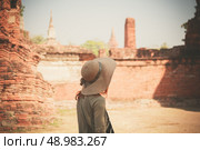 A young woman is exploring the ancient ruins of a buddhist temple city. Стоковое фото, агентство Ingram Publishing / Фотобанк Лори