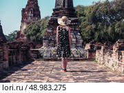 A young woman is exploring the ancient ruins of a buddhist temple city. Стоковое фото, агентство Ingram Publishing / Фотобанк Лори