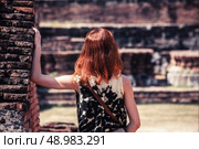 A young woman is exploring the ancient ruins of a buddhist temple city. Стоковое фото, агентство Ingram Publishing / Фотобанк Лори
