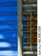 green iron venetian blind and a blue metal wall in la boca buenos aires argentina. Стоковое фото, агентство Ingram Publishing / Фотобанк Лори
