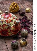 the teapot in the background of elite sorts of tea.the image is tinted in vintage style. Стоковое фото, агентство Ingram Publishing / Фотобанк Лори