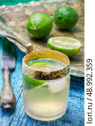 Selective focus.glass alcoholic drink and lime fruits . alcoholic cocktail with additions of lime. Стоковое фото, агентство Ingram Publishing / Фотобанк Лори