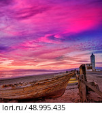 Cabo de Gata in Almeria at San Miguel Beach and Salinas church with stranded boats at sunset. Стоковое фото, агентство Ingram Publishing / Фотобанк Лори
