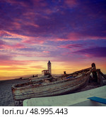 Cabo de Gata in Almeria at San Miguel Beach and Salinas church with stranded boats at sunset. Стоковое фото, агентство Ingram Publishing / Фотобанк Лори