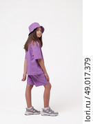 Young Model Enjoys Playful Moments in Stylish Purple Outfit With a Bright Backdrop. Стоковое фото, фотограф Aleksandr Golubev / Фотобанк Лори