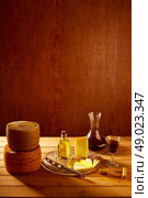 Manchego cheese from Spain with olive oil and red wine on wood. Стоковое фото, агентство Ingram Publishing / Фотобанк Лори