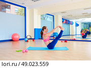 Pilates woman open leg rocker exercise workout at gym indoor. Стоковое фото, агентство Ingram Publishing / Фотобанк Лори