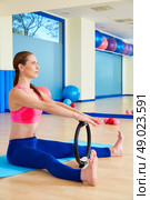 Pilates woman spine stretch forward magic ring exercise workout at gym indoor. Стоковое фото, агентство Ingram Publishing / Фотобанк Лори