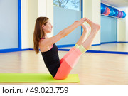 Pilates woman open leg rocker exercise workout at gym indoor. Стоковое фото, агентство Ingram Publishing / Фотобанк Лори