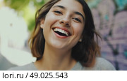 Portrait of young joyful woman outdoors. Smiling female student walks around city. Hair of happy person flutters in wind. Стоковое AI-видео, аниматор Ирина / Фотобанк Лори