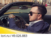 Stylish man sitting in sport car. Стоковое фото, агентство Ingram Publishing / Фотобанк Лори