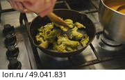 Cooking broccoli in a frying pan close-up. Homemade healthy, veggie food. Roasting broccoli on skillet pan. Chef hand stirring broccoli. Healthy food, vegetarian cuisine. Fry off broccoli stem. Стоковое видео, видеограф Марина Демидюк / Фотобанк Лори