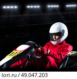 Young woman karting racer at stadium. Стоковое фото, агентство Ingram Publishing / Фотобанк Лори