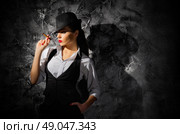 Woman with cigar on grey wall background. Стоковое фото, агентство Ingram Publishing / Фотобанк Лори