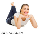 Young girl laying on the floor isolated. Стоковое фото, агентство Ingram Publishing / Фотобанк Лори