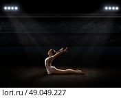 Young girl engaged art gymnastic at sports hall. Стоковое фото, агентство Ingram Publishing / Фотобанк Лори