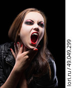 Young vampire girl isolated on black. Стоковое фото, агентство Ingram Publishing / Фотобанк Лори