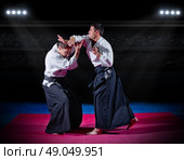 Two aikido fighters at sports hall. Стоковое фото, агентство Ingram Publishing / Фотобанк Лори