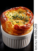 Savory Cheese Souffl Baked in a Ramekin With Fresh Herbs on Top. Стоковое AI-изображение, AI-художник Юлия Гапеенко / Фотобанк Лори