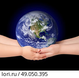 Child and woman holds earth globe on black. Стоковое фото, агентство Ingram Publishing / Фотобанк Лори
