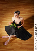 Ballerina in black costume with rose. Стоковое фото, агентство Ingram Publishing / Фотобанк Лори