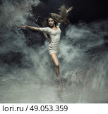 Talented ballet dancer catching the white dust. Стоковое фото, агентство Ingram Publishing / Фотобанк Лори