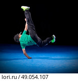 Little boy breakdancer on black. Стоковое фото, агентство Ingram Publishing / Фотобанк Лори