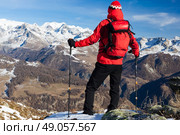 Hiker takes a rest admiring the mountain landscape. Sunny day, early winter. Monte Rosa Massif, Valle d’Aosta, Italy, Europe. Стоковое фото, агентство Ingram Publishing / Фотобанк Лори