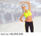 Sporty girl doing gymnastic exercises in fitness club. Стоковое фото, агентство Ingram Publishing / Фотобанк Лори