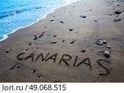 Canarias word written spell in black sand beach Canary Islands of Spain. Стоковое фото, агентство Ingram Publishing / Фотобанк Лори