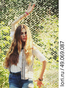 Fashion portrait of beautiful hippie young woman wearing boho chic clothes outdoors. Soft warm vintage color tone. Artsy bohemian style. Стоковое фото, агентство Ingram Publishing / Фотобанк Лори