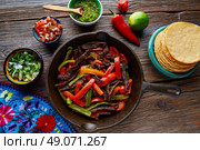 Beef fajitas in a pan with sauces chili and sides Mexican food. Стоковое фото, агентство Ingram Publishing / Фотобанк Лори