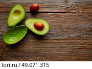 avocado cut on aged wood table board cutted half. Стоковое фото, агентство Ingram Publishing / Фотобанк Лори